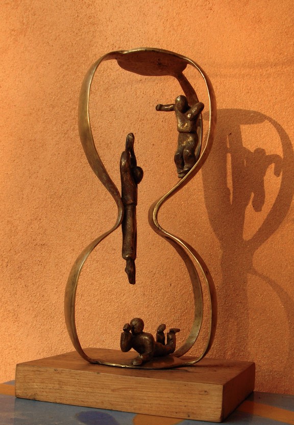 trois personnages dans un sablier pour évoquer le temps qui passe. bronze de flore de valicourt